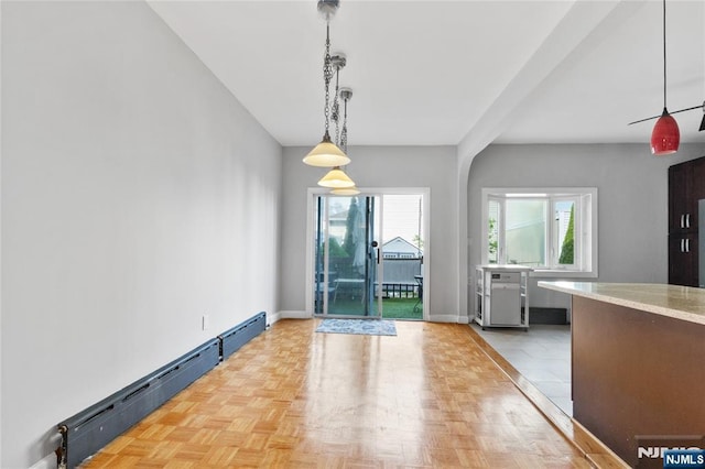 unfurnished dining area featuring baseboards and baseboard heating