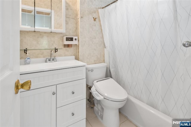 full bathroom featuring tile patterned flooring, vanity, toilet, a shower with shower curtain, and tile walls