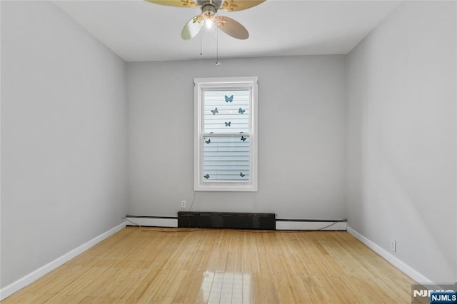 spare room featuring baseboards, a ceiling fan, and hardwood / wood-style flooring