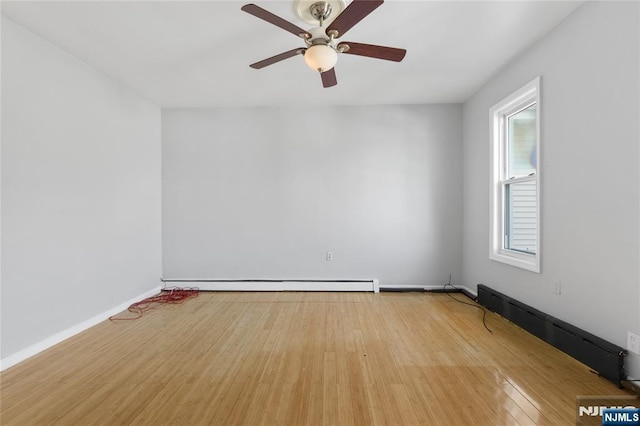 empty room with baseboards, a ceiling fan, a baseboard heating unit, and light wood finished floors