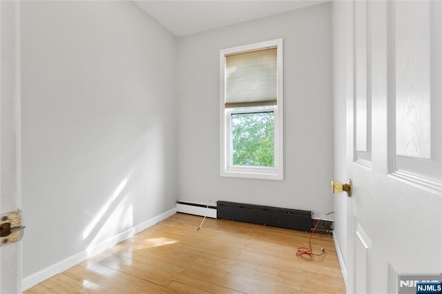 spare room with light wood-style floors and baseboards