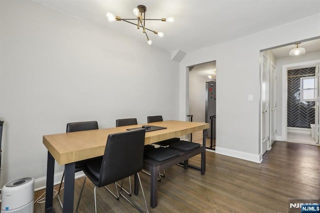 dining space with an inviting chandelier, dark wood-style flooring, and baseboards