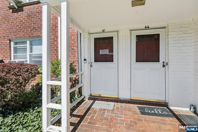 property entrance featuring brick siding