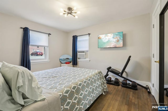 bedroom featuring dark wood-style flooring and baseboards