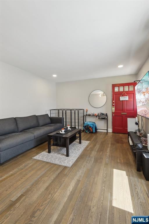 living area featuring recessed lighting and hardwood / wood-style floors