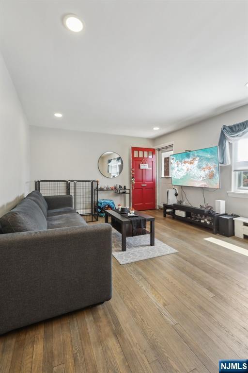 living room with recessed lighting and wood finished floors