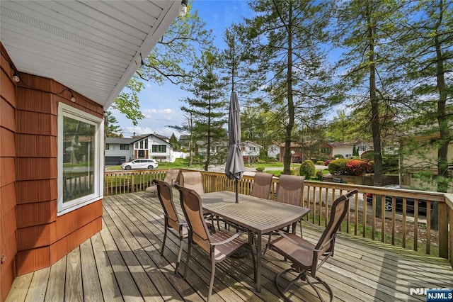 deck featuring a residential view and outdoor dining space