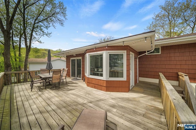 wooden deck with outdoor dining space