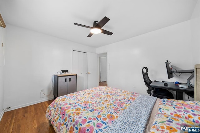 bedroom with a closet, baseboards, ceiling fan, and wood finished floors