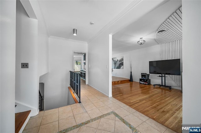 interior space with crown molding and baseboards