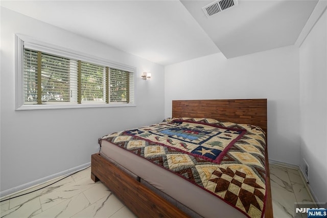 bedroom featuring baseboards, visible vents, and marble finish floor