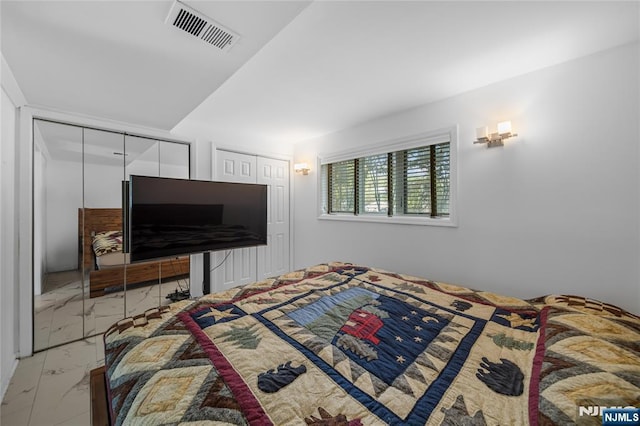 bedroom featuring visible vents and marble finish floor
