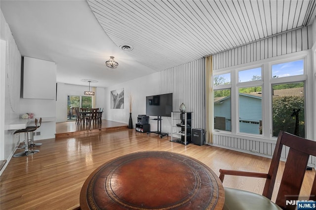 living area with wood finished floors and visible vents