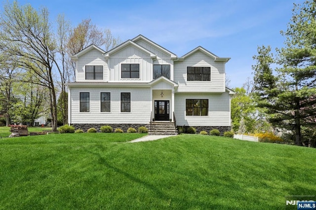 view of front of property with a front lawn and board and batten siding