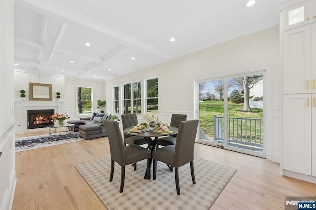 dining room featuring beamed ceiling, a decorative wall, recessed lighting, and light wood-style flooring