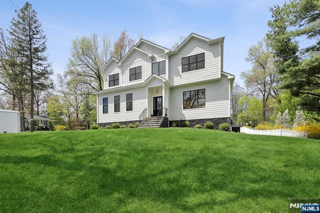 traditional-style house featuring board and batten siding and a front lawn