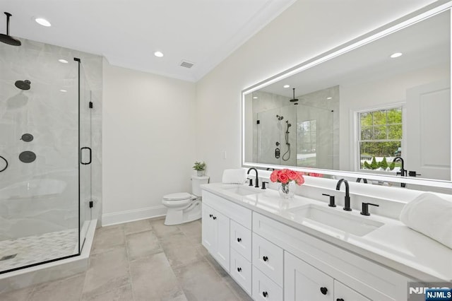 full bathroom featuring double vanity, baseboards, a shower stall, and a sink
