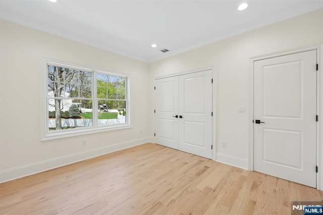 unfurnished bedroom with visible vents, baseboards, a closet, light wood-style floors, and recessed lighting