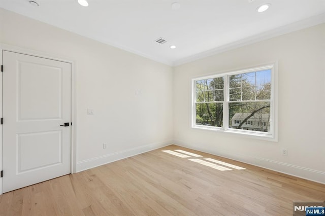 unfurnished room featuring recessed lighting, baseboards, light wood finished floors, and visible vents