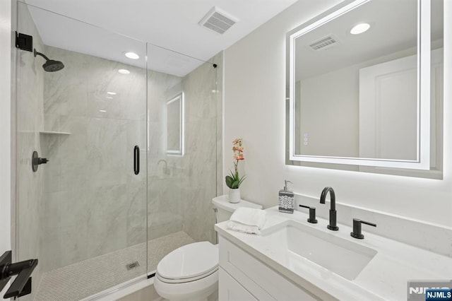 bathroom featuring toilet, visible vents, and a shower stall