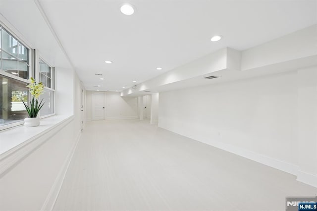 below grade area featuring baseboards, recessed lighting, and visible vents
