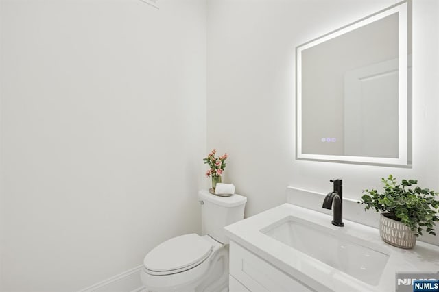 half bath with vanity and toilet
