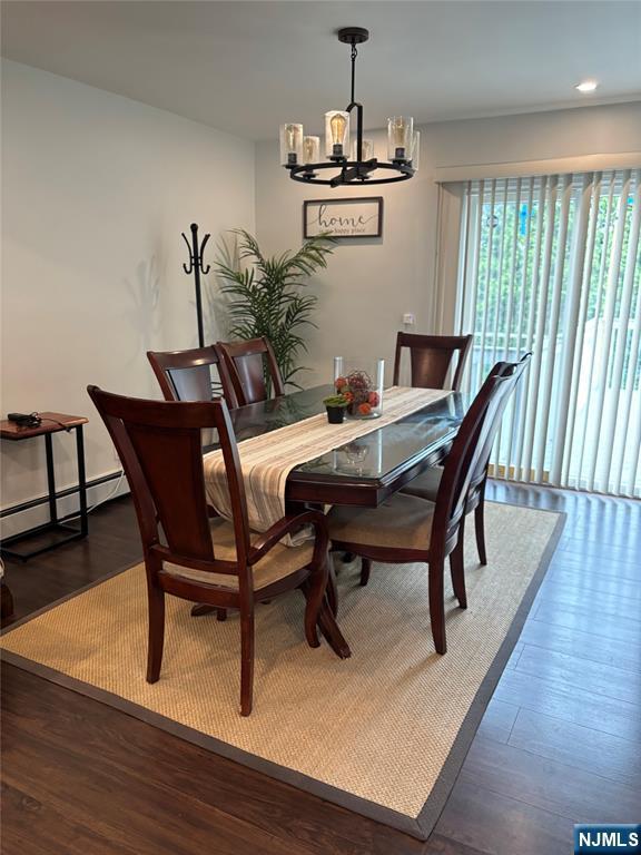 66 Lexington Ave, Rochelle Park, NJ 07662 - dining space with baseboard heating, a chandelier, recessed lighting, and wood finished floors
