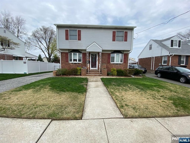 66 Lexington Ave, Rochelle Park, NJ 07662 - colonial house with brick siding, a front lawn, and fence