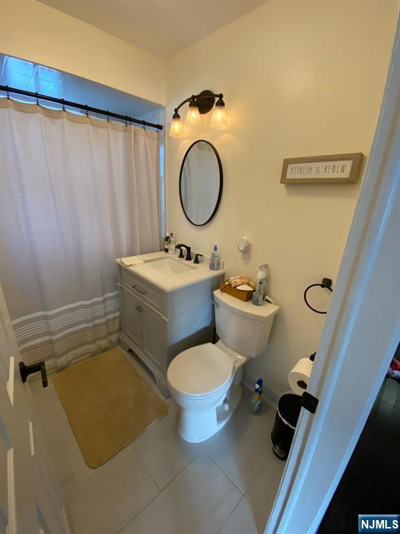 66 Lexington Ave, Rochelle Park, NJ 07662 - bathroom with tile patterned flooring, toilet, and vanity