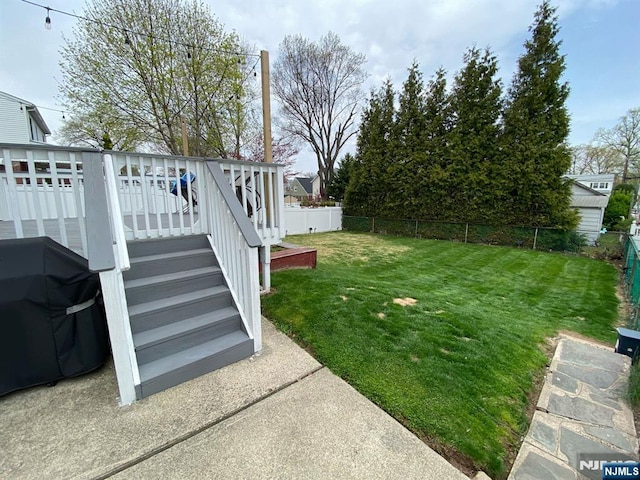 66 Lexington Ave, Rochelle Park, NJ 07662 - view of yard with a wooden deck, a fenced backyard, and stairs