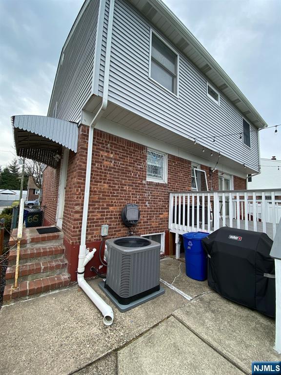 66 Lexington Ave, Rochelle Park, NJ 07662 - back of property with central air condition unit and brick siding