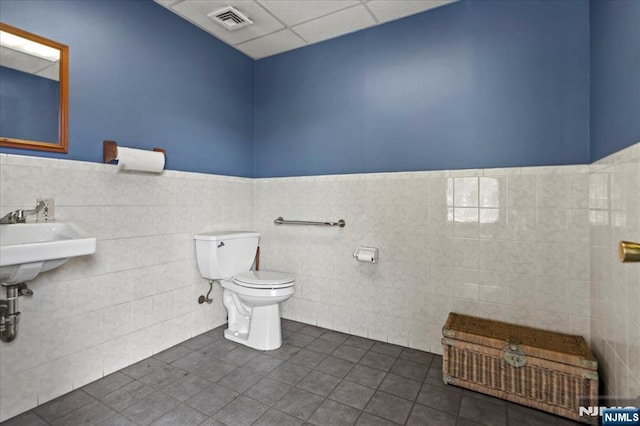 7 White Rd, West Milford, NJ 07421 - bathroom featuring wainscoting, toilet, tile patterned floors, tile walls, and visible vents