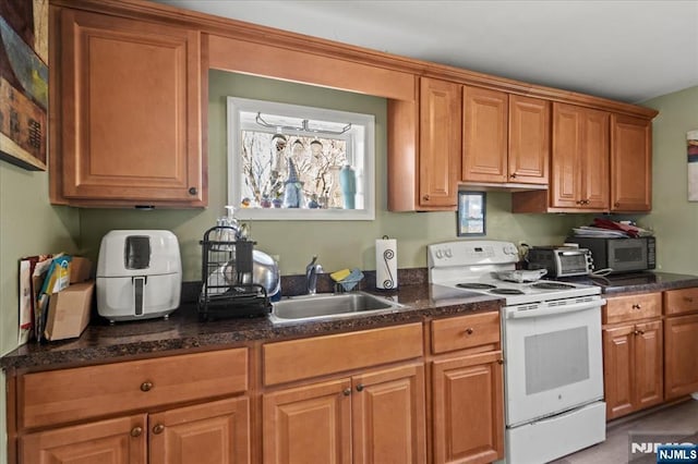 7 White Rd, West Milford, NJ 07421 - kitchen featuring a sink, brown cabinetry, stainless steel microwave, a toaster, and white electric range