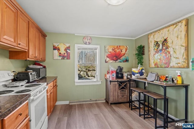 7 White Rd, West Milford, NJ 07421 - kitchen with brown cabinetry, dark countertops, baseboards, white electric range, and light wood-style flooring