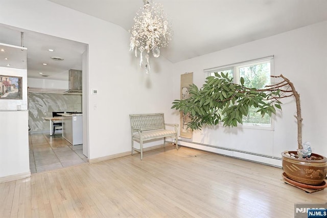 interior space with wood finished floors, baseboards, a baseboard radiator, a chandelier, and recessed lighting