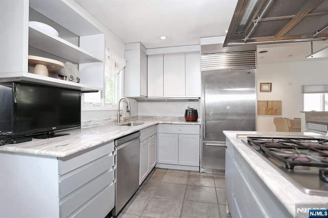 kitchen featuring light tile patterned flooring, open shelves, a sink, stainless steel appliances, and tasteful backsplash