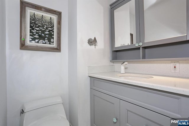bathroom with toilet and vanity