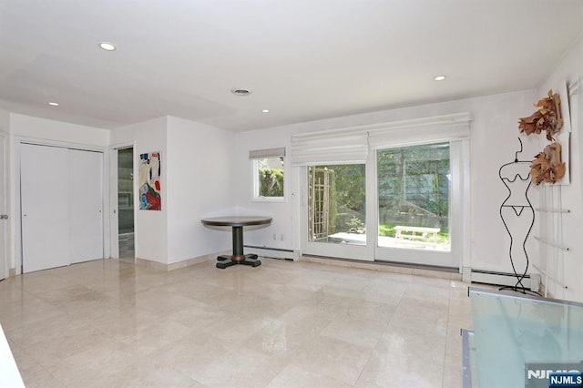 interior space with recessed lighting, baseboards, and baseboard heating