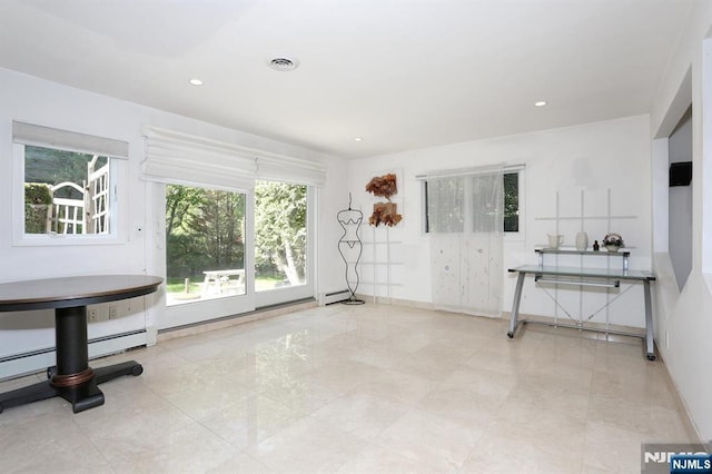 interior space with recessed lighting, baseboards, and a baseboard heating unit