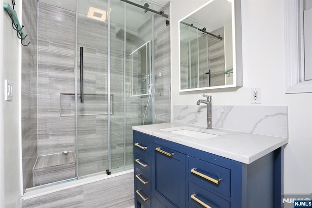 bathroom featuring vanity and a stall shower