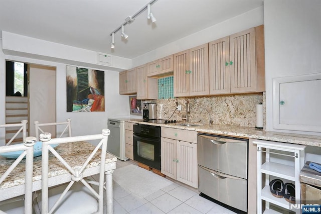 kitchen featuring black oven, rail lighting, backsplash, refrigerator, and dishwashing machine