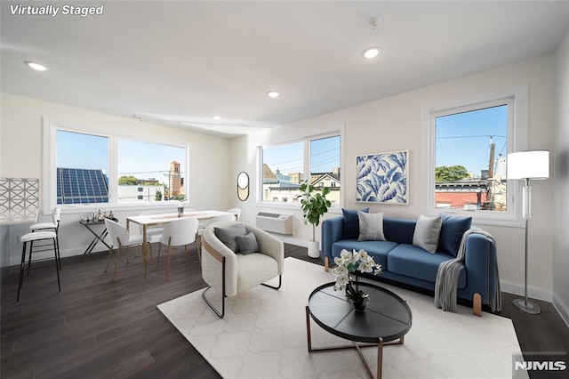 living room featuring baseboards, a wealth of natural light, and wood finished floors