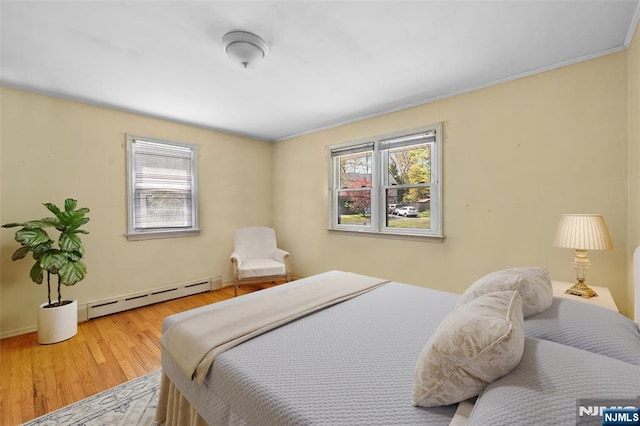 98 Roosevelt Blvd, Oakland, NJ 07436 - bedroom with wood finished floors, a baseboard heating unit, and multiple windows