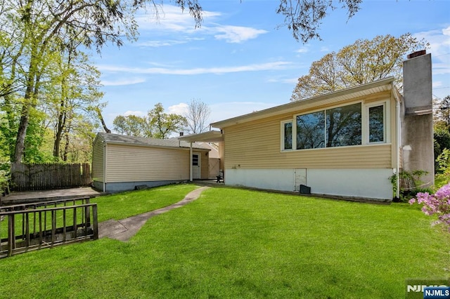 98 Roosevelt Blvd, Oakland, NJ 07436 - back of property featuring fence, a chimney, and a yard