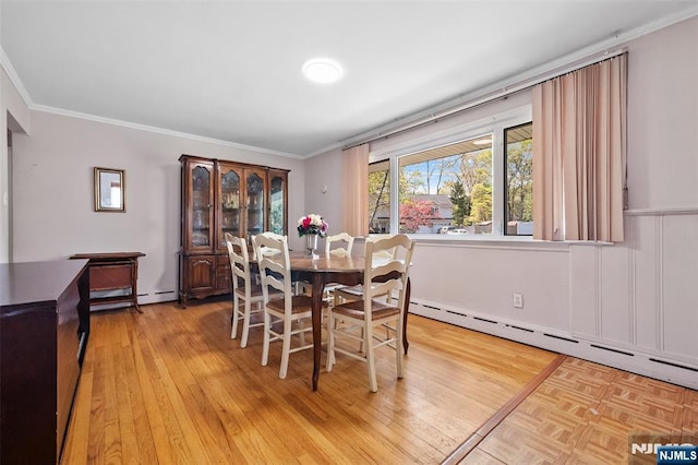 98 Roosevelt Blvd, Oakland, NJ 07436 - dining space featuring a baseboard heating unit, ornamental molding, baseboard heating, and light wood finished floors