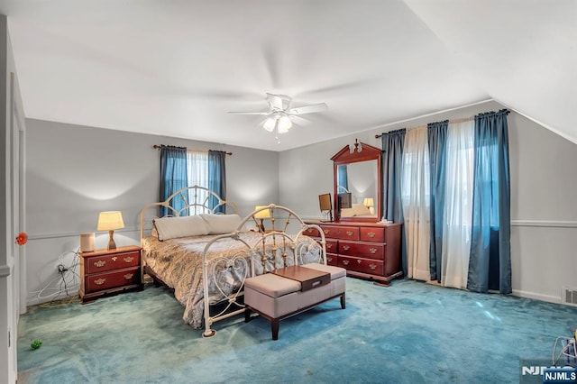 bedroom featuring vaulted ceiling, ceiling fan, carpet flooring, and visible vents
