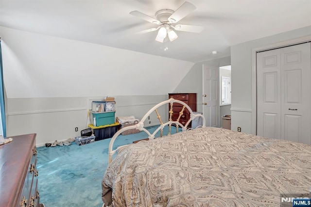 bedroom with carpet flooring, ceiling fan, baseboards, lofted ceiling, and a closet