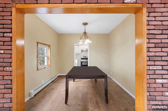 interior space with baseboards, a baseboard radiator, and wood finished floors