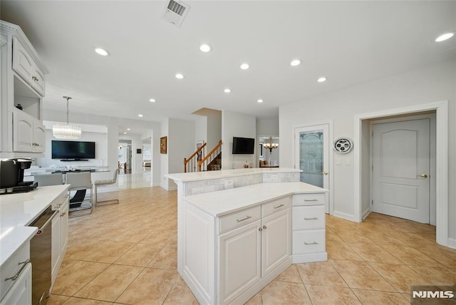 143 S Glen Rd, Kinnelon Borough, NJ 07405 - kitchen with light tile patterned floors, an inviting chandelier, a kitchen island, and open floor plan