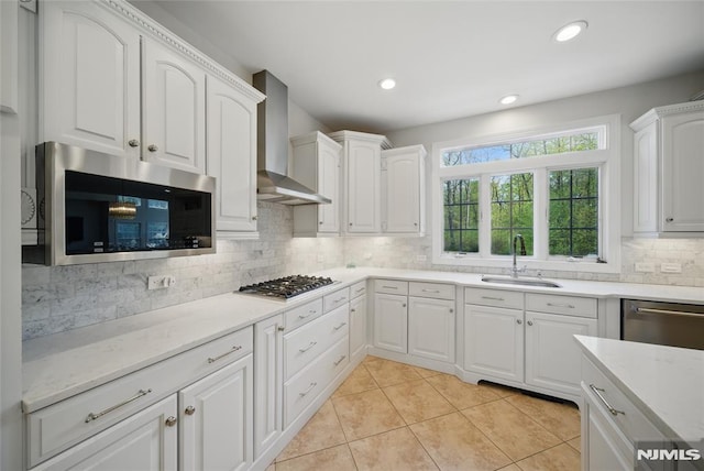 143 S Glen Rd, Kinnelon Borough, NJ 07405 - kitchen with wall chimney range hood, white cabinetry, a sink, backsplash, and stainless steel appliances